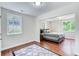 Sun-filled bedroom with hardwood floors, comfortable bed and large windows overlooking the exterior at 2742 Alpine Rd, Atlanta, GA 30305