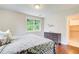 Bright bedroom features hardwood floors, a dresser, and a large window offering a serene outdoor view at 2742 Alpine Rd, Atlanta, GA 30305