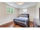 Bright bedroom with hardwood floors, two windows with nature views, and modern furnishings at 2742 Alpine Rd, Atlanta, GA 30305