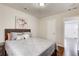 Well-lit bedroom with wood floors, a patterned bedspread, and a closet at 2742 Alpine Rd, Atlanta, GA 30305