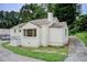 Quaint white brick home with a paved driveway, chimney, and mature trees in a landscaped yard at 2742 Alpine Rd, Atlanta, GA 30305