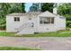 A charming one-story home features a white brick facade, front entrance staircase, and ample natural light at 2742 Alpine Rd, Atlanta, GA 30305