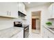 Kitchen area featuring white cabinets, subway tile backsplash, and granite countertops at 2742 Alpine Rd, Atlanta, GA 30305