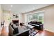 A cozy living room features hardwood floors, a fireplace, large window, neutral walls, and modern furniture at 2742 Alpine Rd, Atlanta, GA 30305