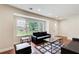 A bright living room features hardwood floors, a large window, neutral walls, and stylish furniture at 2742 Alpine Rd, Atlanta, GA 30305