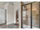 Modern bathroom featuring a glass shower, gray tile, and access to a closet at 271 Learwood Ln, Atlanta, GA 30349