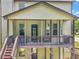 Covered wooden deck with seating area, grill and stairs to the yard at 271 Learwood Ln, Atlanta, GA 30349