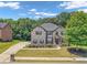 Charming two-story brick home with mature shade tree and lovely landscaping at 271 Learwood Ln, Atlanta, GA 30349