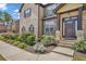 Attractive brick home with a stylish front door, complemented by lush landscaping and manicured flower beds at 271 Learwood Ln, Atlanta, GA 30349