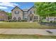 Charming two-story brick home with a well-manicured lawn and flowering bushes, showcasing curb appeal at 271 Learwood Ln, Atlanta, GA 30349
