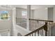 Open landing area with decorative chandelier, railing, and natural light at 271 Learwood Ln, Atlanta, GA 30349