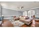 Open living room featuring hardwood floors, a ceiling fan, and a comfortable sectional couch at 271 Learwood Ln, Atlanta, GA 30349