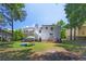 Large, grassy backyard features a deck, trees, and play area for outdoor enjoyment at 3856 Nowlin Nw Rd, Kennesaw, GA 30144
