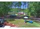 Wooded backyard with play structures, trampoline and greenhouse at 3856 Nowlin Nw Rd, Kennesaw, GA 30144