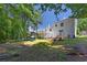 Expansive backyard with a multi-level deck, grassy lawn and lots of shady trees at 3856 Nowlin Nw Rd, Kennesaw, GA 30144