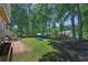 Large private, partially wooded backyard includes a play area and firepit at 3856 Nowlin Nw Rd, Kennesaw, GA 30144
