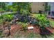 Landscaped backyard featuring a decorative koi pond, mulch, and a variety of lush greenery and shrubs at 3856 Nowlin Nw Rd, Kennesaw, GA 30144
