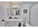 Bright bathroom with a white vanity, framed mirror, and a shower with a white curtain at 3856 Nowlin Nw Rd, Kennesaw, GA 30144