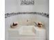 Relaxing bathroom featuring a large soaking tub with decorative touches at 3856 Nowlin Nw Rd, Kennesaw, GA 30144