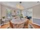 Bright dining room with natural light, hardwood floors, stylish chandelier, and an adjacent living area at 3856 Nowlin Nw Rd, Kennesaw, GA 30144