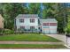 Charming two-story home featuring a covered front porch, red shutters, and a well-manicured lawn at 3856 Nowlin Nw Rd, Kennesaw, GA 30144