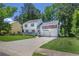 Charming two-story home featuring a covered front porch, red shutters, two-car garage, and a long driveway at 3856 Nowlin Nw Rd, Kennesaw, GA 30144