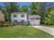 Charming two-story home featuring a covered front porch, red shutters, and a well-manicured lawn at 3856 Nowlin Nw Rd, Kennesaw, GA 30144
