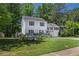 Charming two-story home featuring a covered front porch, red shutters, and a well-manicured lawn at 3856 Nowlin Nw Rd, Kennesaw, GA 30144