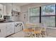 Charming kitchen nook with natural light, white cabinets, modern appliances, and a cozy eating area at 3856 Nowlin Nw Rd, Kennesaw, GA 30144