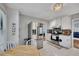 Spacious kitchen featuring stainless steel appliances, white cabinetry, and easy access to an adjacent living area at 3856 Nowlin Nw Rd, Kennesaw, GA 30144