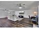 Spacious living area with hardwood floors, comfortable seating, ceiling fans, and a wall-mounted television at 3856 Nowlin Nw Rd, Kennesaw, GA 30144