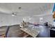 Large living room features hardwood floors, stylish ceiling fans, plenty of natural light, and comfortable seating at 3856 Nowlin Nw Rd, Kennesaw, GA 30144