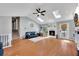 Spacious living room featuring a fireplace, skylights, hardwood floors, and comfortable seating at 3856 Nowlin Nw Rd, Kennesaw, GA 30144