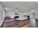 Expansive living room with hardwood flooring, recessed lighting, ceiling fans, and sliding doors to the outside at 3856 Nowlin Nw Rd, Kennesaw, GA 30144