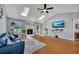 Bright living room with a vaulted ceiling, skylights, a fireplace, hardwood floors, and a comfortable seating area at 3856 Nowlin Nw Rd, Kennesaw, GA 30144