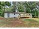 The property's backyard has a deck and mature trees offering shade at 396 Independence Dr, Jonesboro, GA 30238