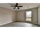 This bedroom features a ceiling fan, hardwood floors, and a window with a view at 396 Independence Dr, Jonesboro, GA 30238
