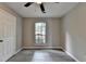 This bedroom offers a ceiling fan, gray walls and attractive wood-look flooring at 396 Independence Dr, Jonesboro, GA 30238