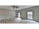 Spacious empty bedroom with updated flooring, two windows and modern ceiling fan at 396 Independence Dr, Jonesboro, GA 30238