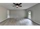 The empty bedroom features updated flooring, a window for light and ceiling fan at 396 Independence Dr, Jonesboro, GA 30238