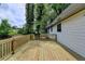 Wide shot of a wooden deck with wood railing in the backyard with wooded views at 396 Independence Dr, Jonesboro, GA 30238