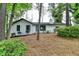 Home exterior surrounded by mature trees with front landscaping and wood siding at 396 Independence Dr, Jonesboro, GA 30238