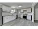 Modern kitchen with white cabinets, granite countertops, stainless steel appliances and gray subway tile at 396 Independence Dr, Jonesboro, GA 30238