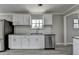 Kitchen with granite countertops, white cabinets and stainless steel appliances with a white subway tile backsplash at 396 Independence Dr, Jonesboro, GA 30238