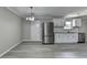 Bright kitchen features stainless steel appliances, white cabinets, light gray paint and updated light fixture at 396 Independence Dr, Jonesboro, GA 30238