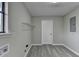 Bright laundry room features grey walls and wood-look floors, plus shelving and washer/dryer hookups at 396 Independence Dr, Jonesboro, GA 30238
