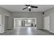 Open concept living room and kitchen area with gray floors and a ceiling fan at 396 Independence Dr, Jonesboro, GA 30238