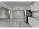 Spacious open-concept living area with gray walls and hardwood floors leading to the kitchen at 396 Independence Dr, Jonesboro, GA 30238