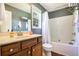 This bathroom features a shower-tub combo and a wood vanity with sink at 6195 Queensdale Dr, Douglasville, GA 30135