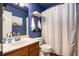 Cozy bathroom featuring a wood vanity, and a combination shower and tub at 6195 Queensdale Dr, Douglasville, GA 30135